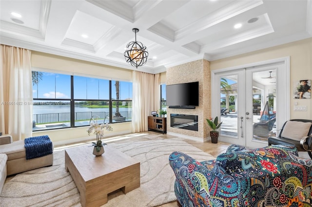 living room featuring beamed ceiling, ornamental molding, coffered ceiling, a water view, and french doors