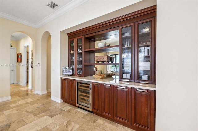 bar featuring crown molding and beverage cooler