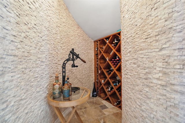 wine room with vaulted ceiling