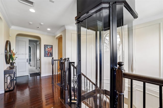 hall with crown molding and dark hardwood / wood-style flooring