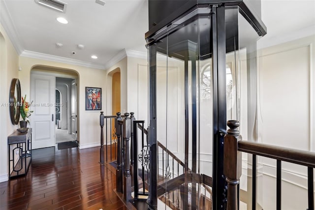 corridor featuring crown molding and dark hardwood / wood-style flooring