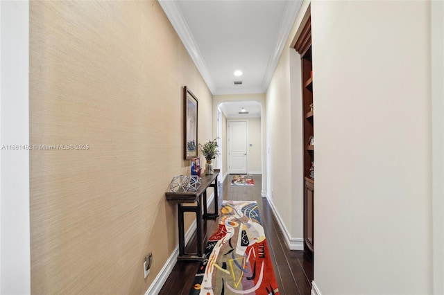 corridor with dark wood-type flooring and ornamental molding