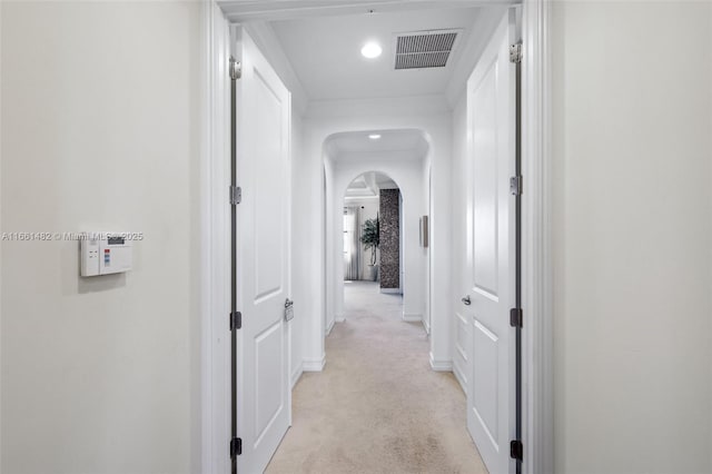 corridor featuring light colored carpet