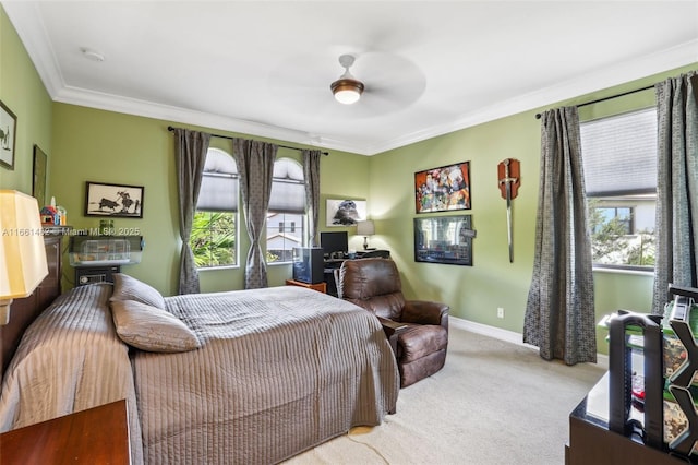 carpeted bedroom with multiple windows, ceiling fan, and ornamental molding