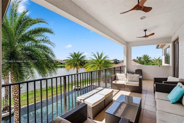 balcony with ceiling fan, a water view, and an outdoor hangout area