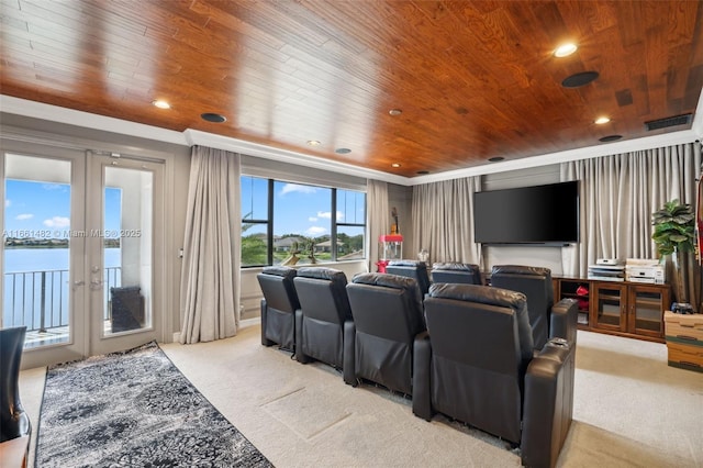 carpeted home theater room with wood ceiling and french doors