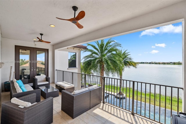 view of patio / terrace with a water view, ceiling fan, an outdoor living space, and french doors