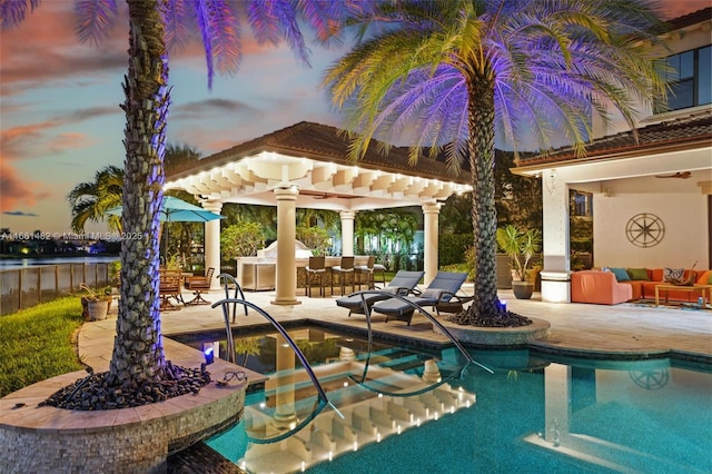 pool at dusk featuring a patio, a jacuzzi, and french doors