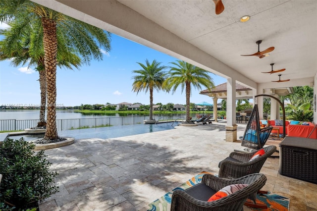 view of patio with a water view, outdoor lounge area, and ceiling fan