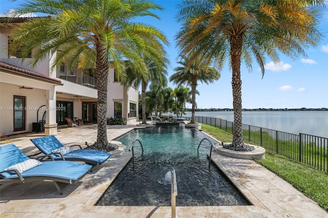 view of pool with a water view and a patio area