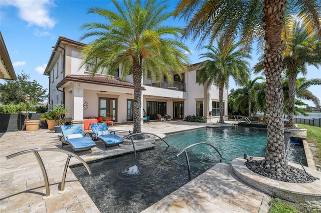 view of swimming pool featuring french doors and a patio area