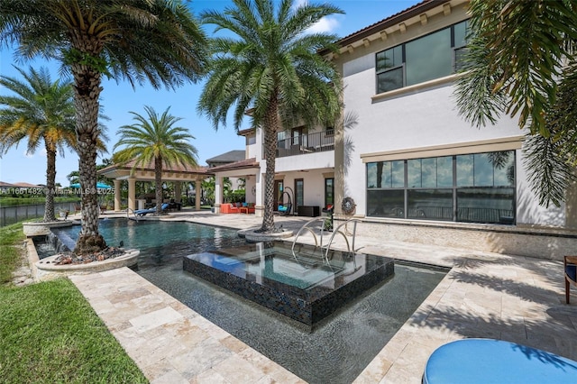 view of pool featuring an in ground hot tub, a patio, and a gazebo