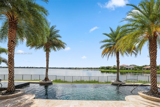 view of swimming pool featuring a water view
