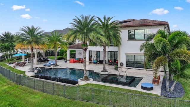 view of pool featuring an in ground hot tub, a lawn, and a patio area