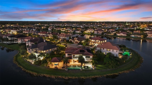 aerial view at dusk with a water view