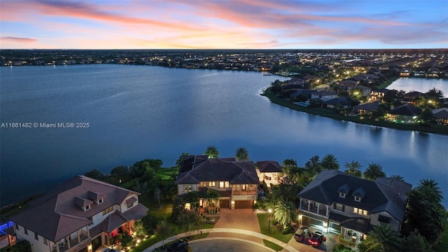 aerial view at dusk with a water view