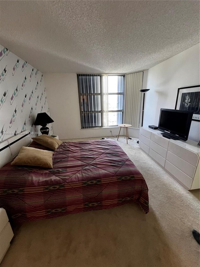 carpeted bedroom featuring a textured ceiling