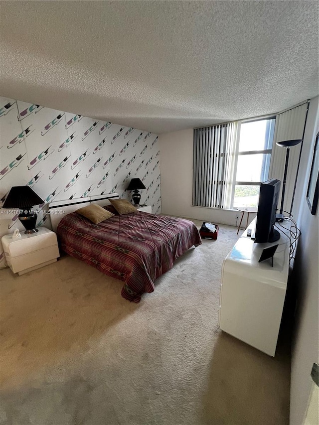 bedroom featuring a textured ceiling and carpet flooring