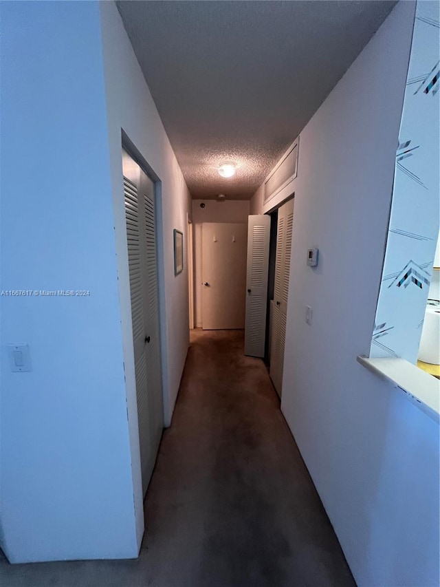 hallway featuring a textured ceiling