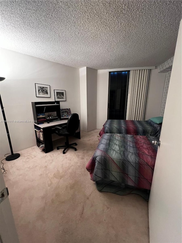 bedroom featuring a textured ceiling and carpet floors