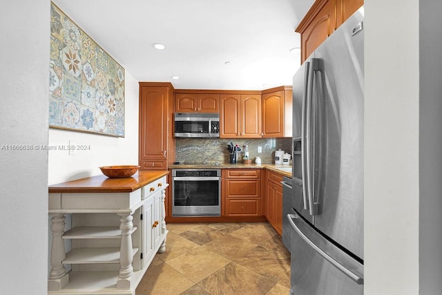 kitchen with appliances with stainless steel finishes and tasteful backsplash