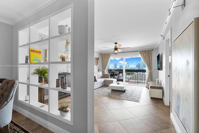 tiled living room with ceiling fan and crown molding