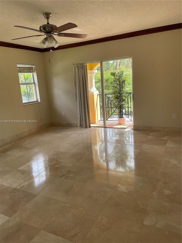 spare room with ceiling fan, crown molding, and a textured ceiling