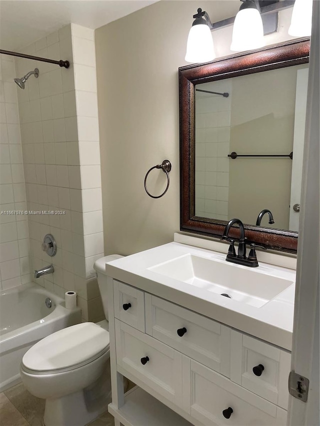 full bathroom featuring tiled shower / bath combo, vanity, toilet, and tile patterned floors