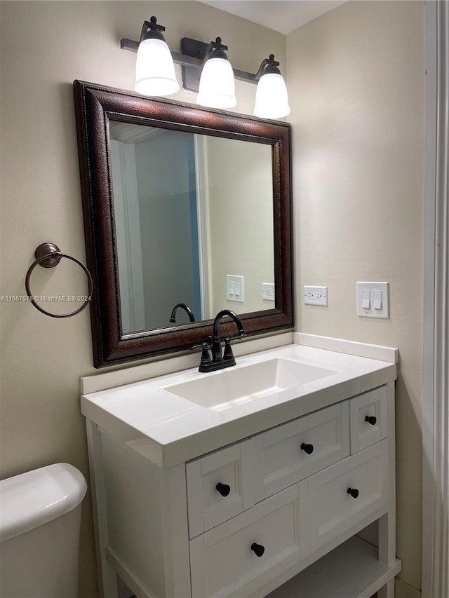 bathroom featuring vanity and toilet