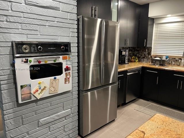 kitchen featuring appliances with stainless steel finishes, backsplash, and light tile patterned floors