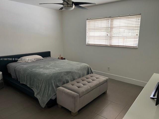 bedroom featuring ceiling fan and tile patterned flooring