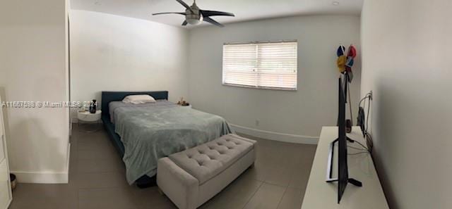 bedroom with ceiling fan, light tile patterned flooring, and lofted ceiling