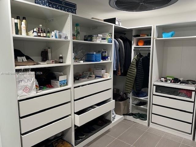 spacious closet featuring light tile patterned floors