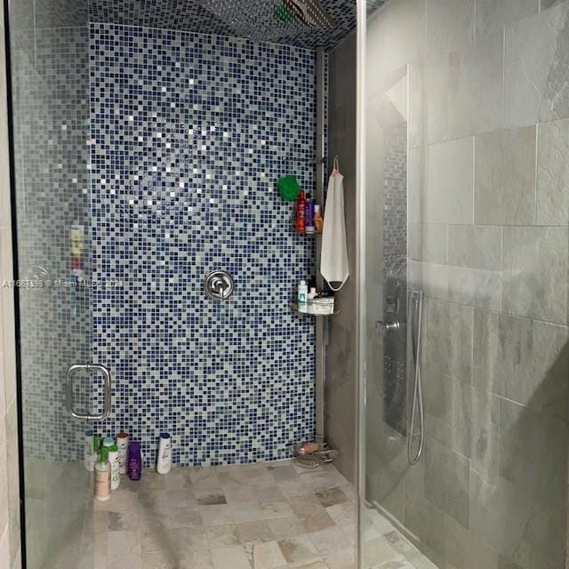 bathroom with an enclosed shower and tile walls