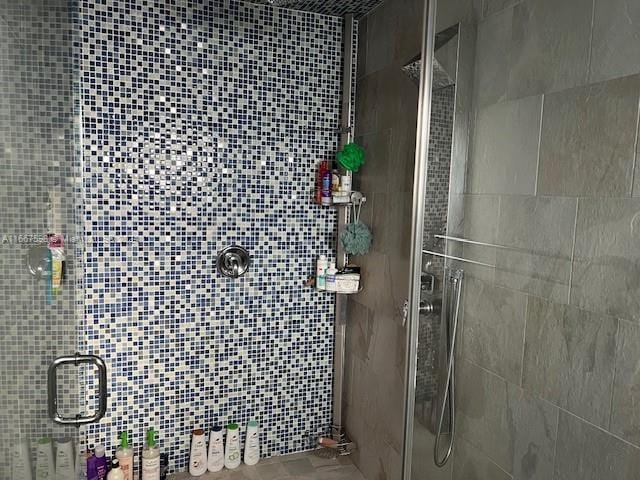 bathroom with tile walls and walk in shower