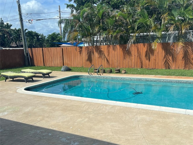 view of swimming pool with a patio