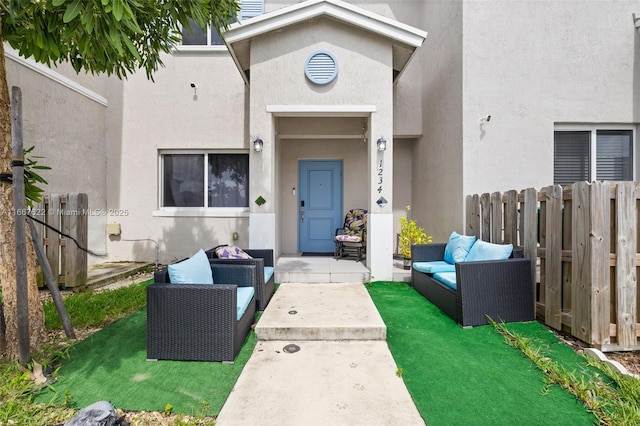 doorway to property with an outdoor hangout area and a lawn