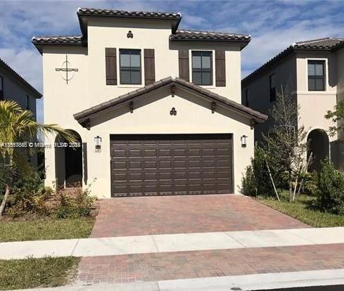 mediterranean / spanish-style home featuring a garage