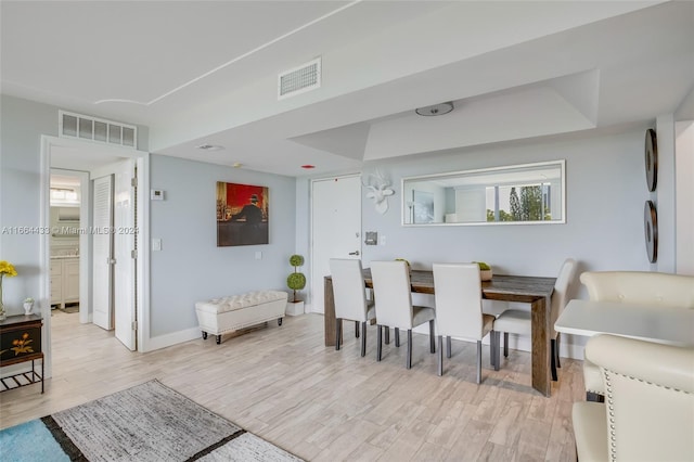 dining area with light hardwood / wood-style floors