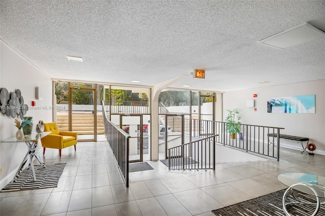 interior space featuring a wall of windows and a textured ceiling