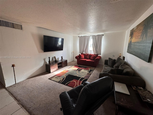 tiled living room featuring a textured ceiling