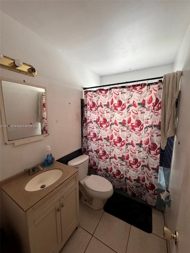 bathroom with vanity, tile patterned flooring, and toilet