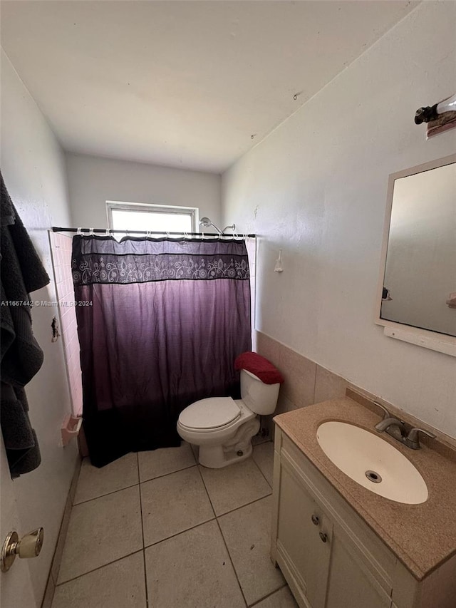 bathroom featuring tile walls, tile patterned floors, vanity, and toilet