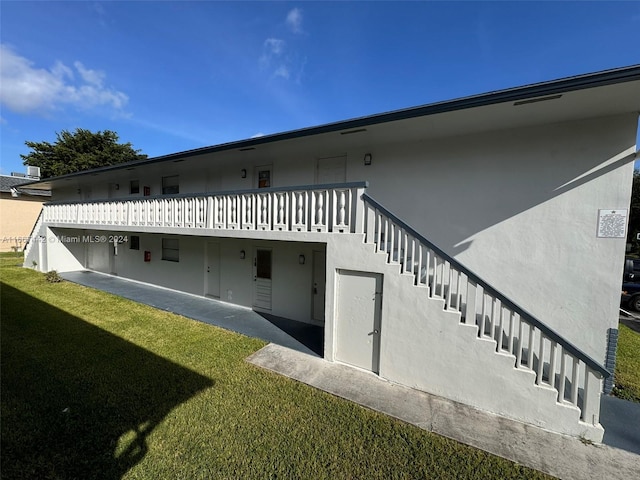 back of property featuring a yard and a patio