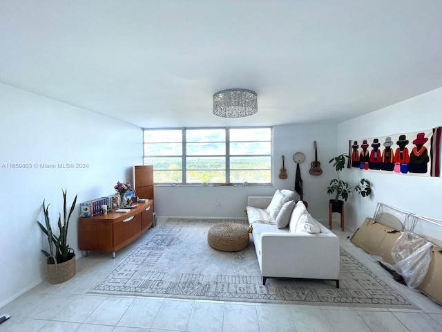 tiled living room featuring an inviting chandelier