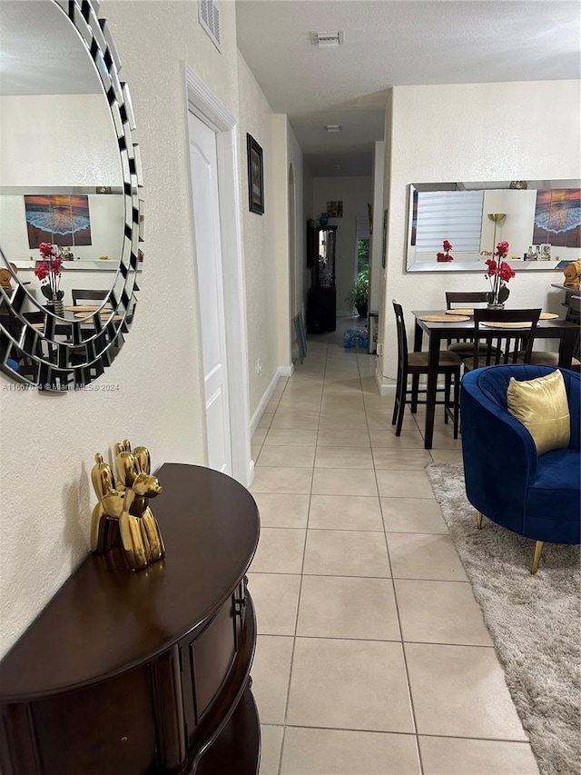 hallway featuring light tile patterned flooring