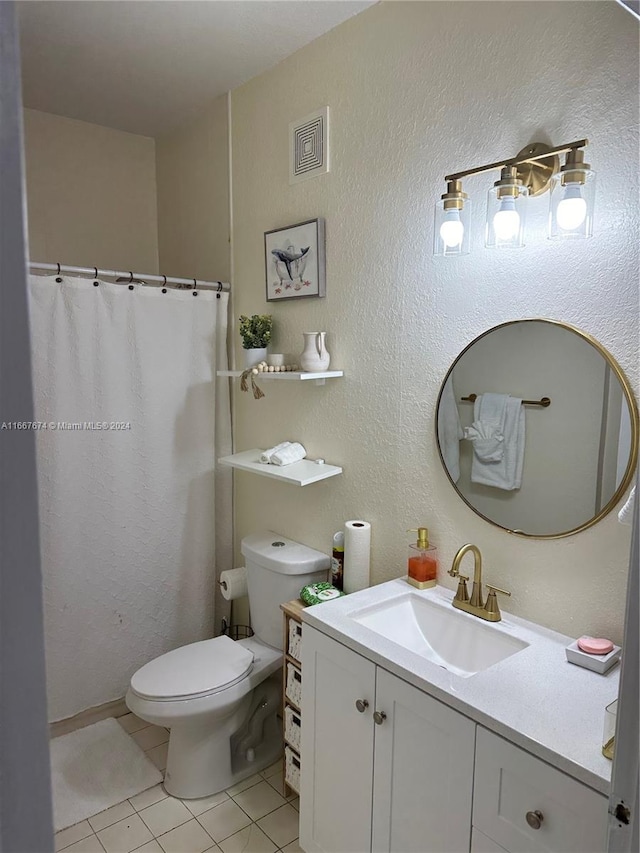 bathroom featuring tile patterned floors, vanity, and toilet