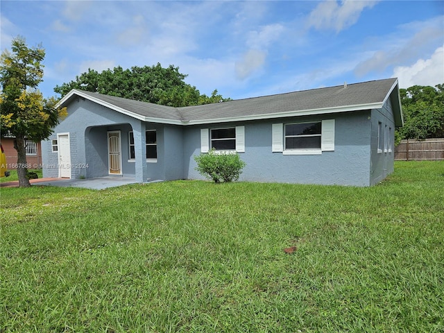 view of front of house with a patio area and a front yard