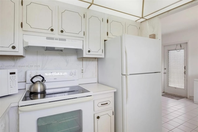 kitchen featuring white cabinetry, white appliances, and tasteful backsplash