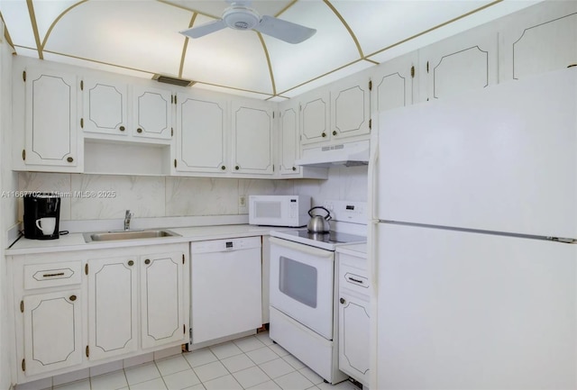 kitchen featuring light tile patterned flooring, backsplash, white appliances, and decorative light fixtures